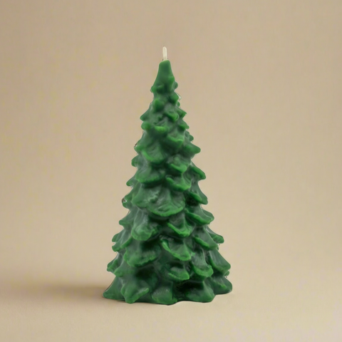 Green Christmas tree-shaped candle on a white background