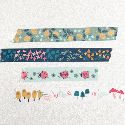 Set of colorful washi tape rolls with floral and nature-themed designs on a white background.