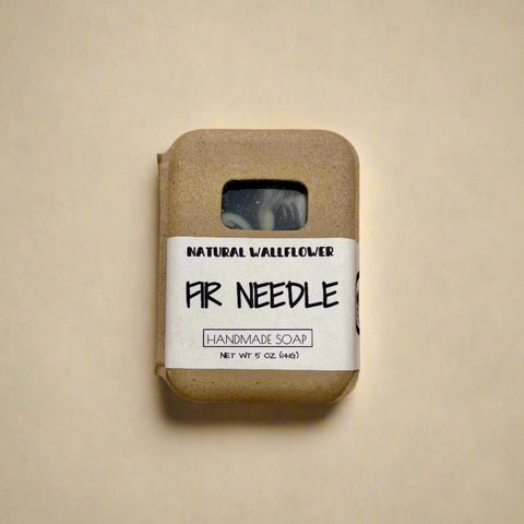 Handmade soap bar with a label on a wooden surface