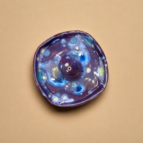 Ceramic incense holder on a wooden surface