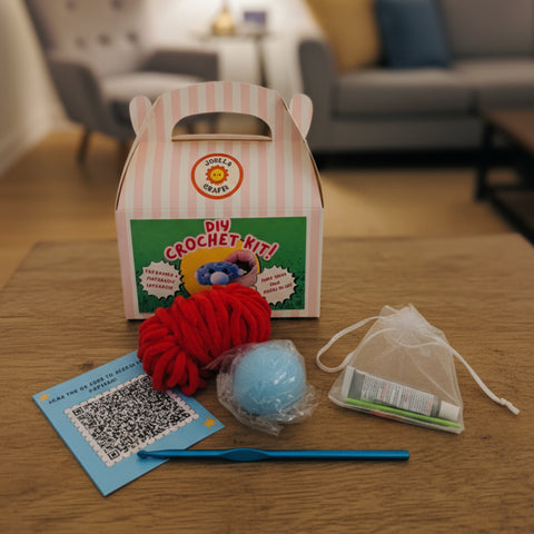 DIY crochet kit with yarn and tools on a wooden table