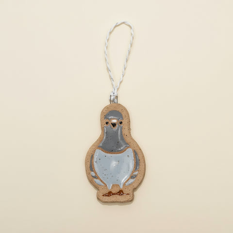 Pigeon-shaped ornament on a wooden surface