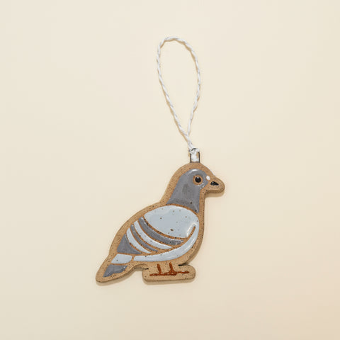 Decorative pigeon ornament on a wooden surface