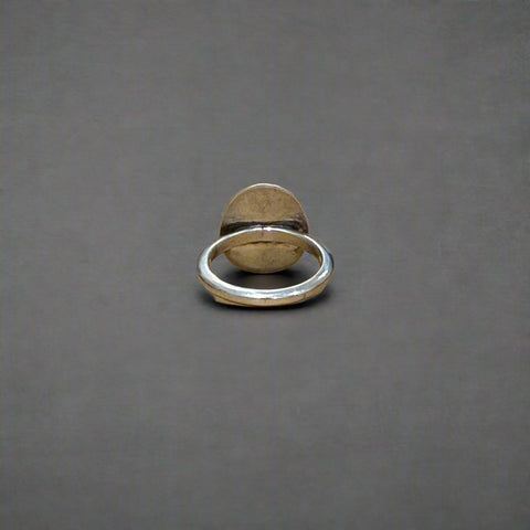 Silver ring on a wooden surface
