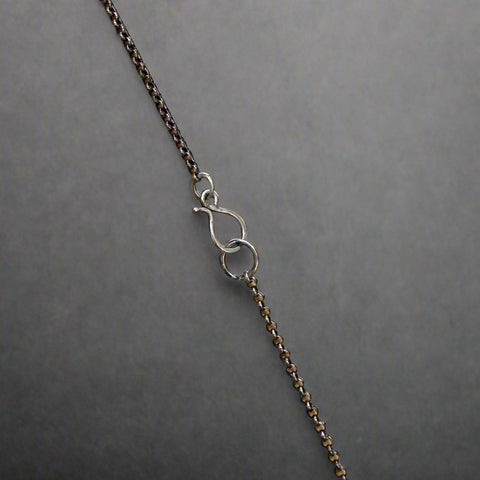 Necklace with a clasp on a wooden surface