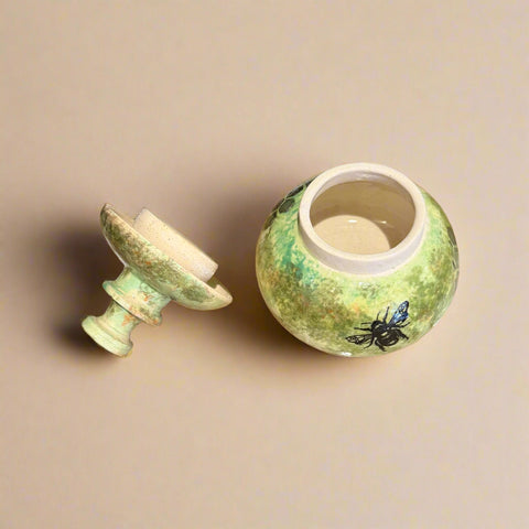 Green ceramic jar with bee design