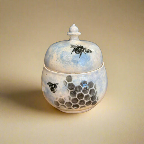 Ceramic jar with bee and honeycomb design