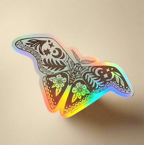 Holographic butterfly sticker on a tan surface