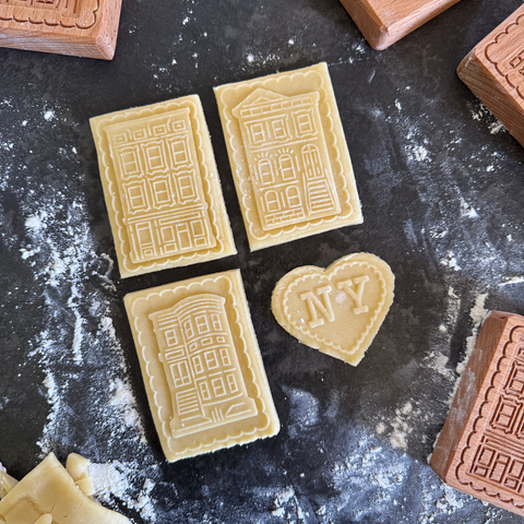 Decorative cookies with embossed designs on a flour-dusted surface