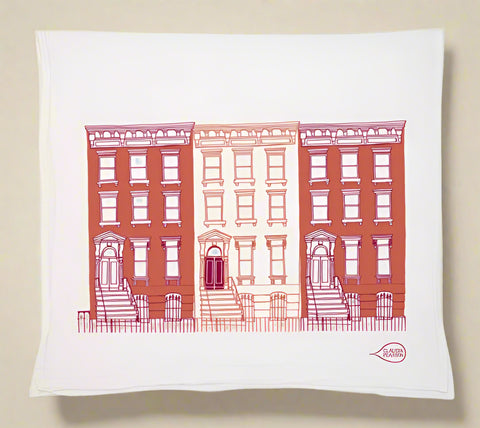 tea towel with red brick building design on a white background