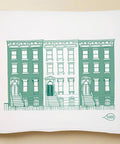 Tea towel with green building illustration on a white background