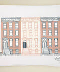 tea towel with illustration of three brownstones on a white background