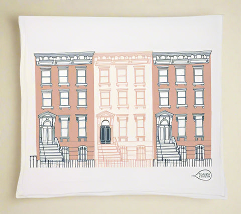 tea towel with illustration of three brownstones on a white background