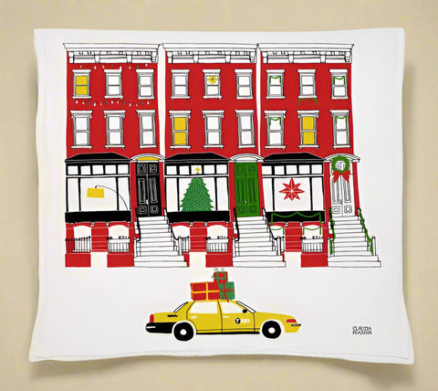 Decorative tea towel with a New York City-themed design featuring a yellow taxi, red building, and Christmas tree.