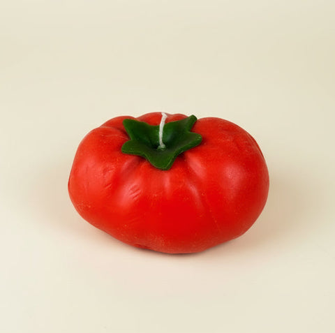 Can of tomato paste with a tomato-shaped object on a checkered cloth background