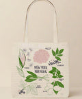 Tote bag with botanical illustrations and text on a white background