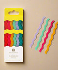 Packaged colorful wavy candles with a 'Talking Tables' label on a white background