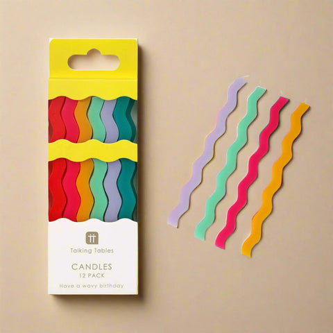 Packaged colorful wavy candles with a 'Talking Tables' label on a white background