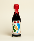 Bottle of Cabi Umami Dashi Soy Sauce on a white background
