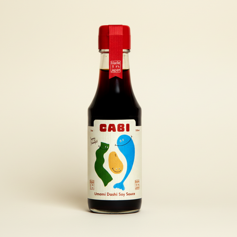 Bottle of Cabi Umami Dashi Soy Sauce on a white background