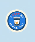 Round sticker with 'I Love My Local Deli' text and a deli lunch bag graphic on a blue background.