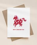 Greeting card with a red horse design and 'Happy Lunar New Year' text on a beige background