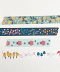 Set of colorful washi tape rolls with floral and nature-themed designs on a white background.