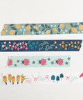 Stack of colorful washi tape rolls on a white background