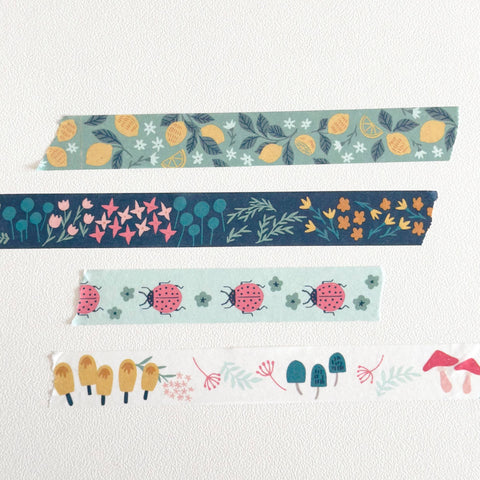 Stack of colorful washi tape rolls on a white background