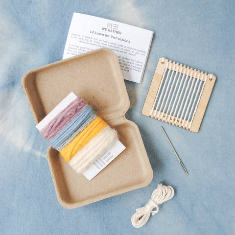 Knitting kit with yarn, needles, and instructions on a blue background