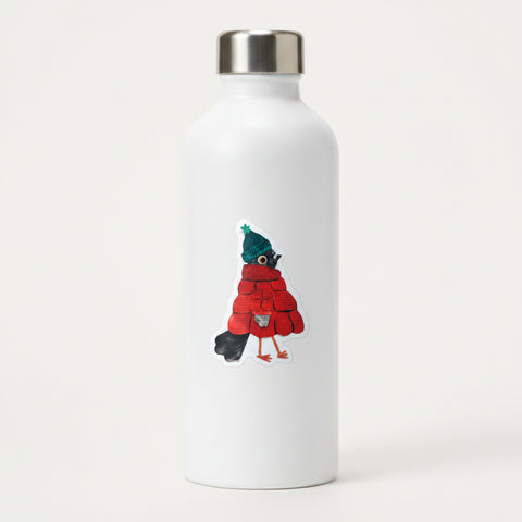 A die-cut sticker featuring a whimsical illustration of a bird dressed in a red knit sweater and a dark green knit hat with a small green pom-pom, shown on a light cream background.