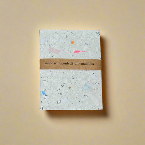 Notebook with confetti design on a cardboard background