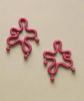 Polymer clay earrings on a wooden surface