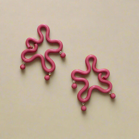 Polymer clay earrings on a wooden surface