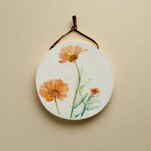 Round floral wall hanging on a wooden surface