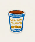 A hand-painted papier mache cup wall art featuring a blue and white Greek key pattern, yellow text reading 'WE ARE HAPPY TO SERVE YOU', and three small yellow cups.