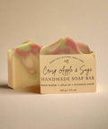 Handmade soap bar with 'Crisp Apple & Sage' scent on a wooden surface.