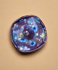 Ceramic incense holder on a wooden surface