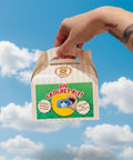 Hand holding a DIY crochet kit packaging