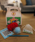 DIY crochet kit with yarn and tools on a wooden table