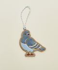 Decorative pigeon ornament on a wooden surface