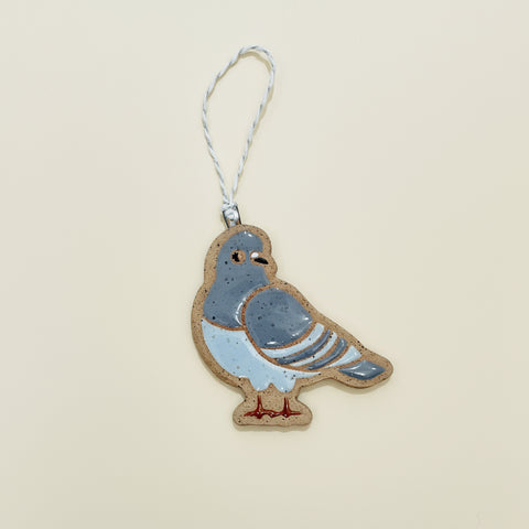 Decorative pigeon ornament on a wooden surface