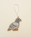Decorative pigeon ornament on a wooden surface