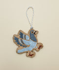 Decorative bird ornament on a wooden surface
