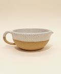 Speckled white ceramic salad dressing bowl