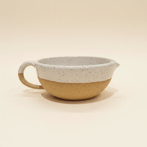 Speckled white ceramic salad dressing bowl
