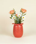 Red ceramic vase with flowers