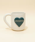 White mug with a dark green heart with 'Greenpoint' text written across it.
