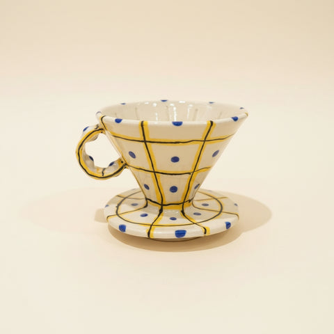 Ceramic coffee filter with geometric design on a wooden surface