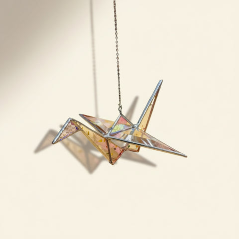 Metallic star-shaped object on a wooden surface with a blurred background